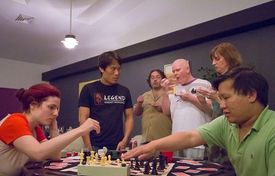 Jennifer plays Kenny Shei, with Terrence Chan looking on at 2012 WSOP. Credit: Rodney Chen