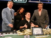 Brett Faustman (seated) celebrates his WPT Tunica World Poker Open victory with Mike Sexton, Layla Kayleigh, and Vince Van Patten