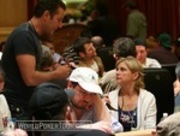 Marco Traniello (standing) checks in with his wife, Jennifer Harman, on Day 1b of the WPT World Championship