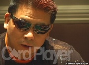 Card Player talks to Johnny Chan and chip leader Scott Fischman before play starts on Day 2.