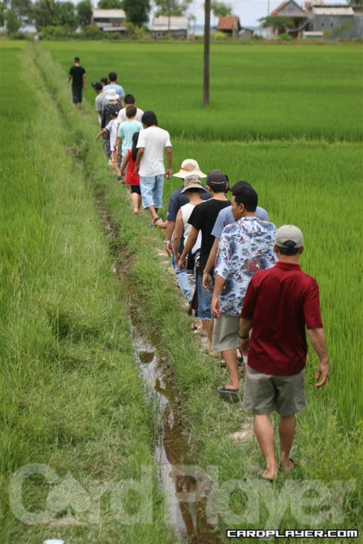 John Phan Leads his Family into a Village