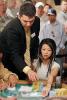 Johnny Grooms verifies the chip count for Liz Lieu after she makes the final table on day two of Event #2 ($1,500 No-Limit Hold'em).