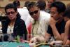 Scotty Nguyen and John Phan look on as Nick Mao considers his next action on day one of the World Series of Poker Circuit Championship in Las Vegas.